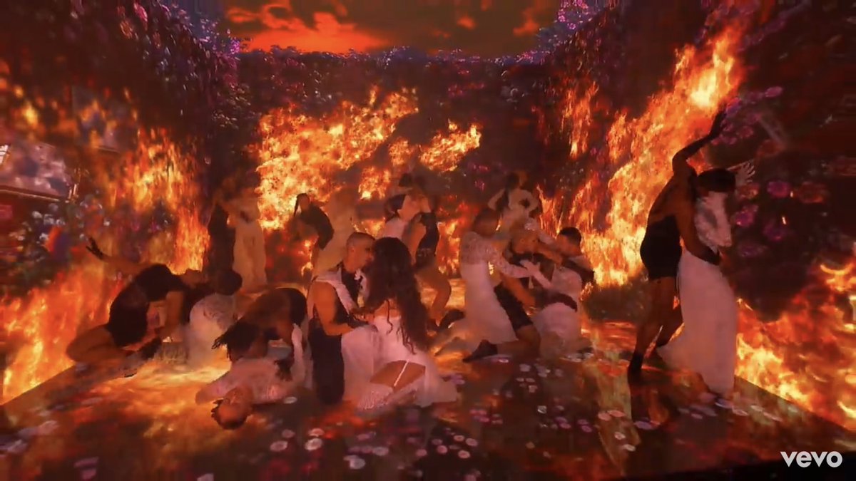 After she throws it in the air we reach to the well known “Orgy” scene where the good meets bad. An orgy between “demons” and “angels” as it is portrayed here, is a very strong symbolism for falling into sinful situations. Especially since the song indicates a sexual activity.