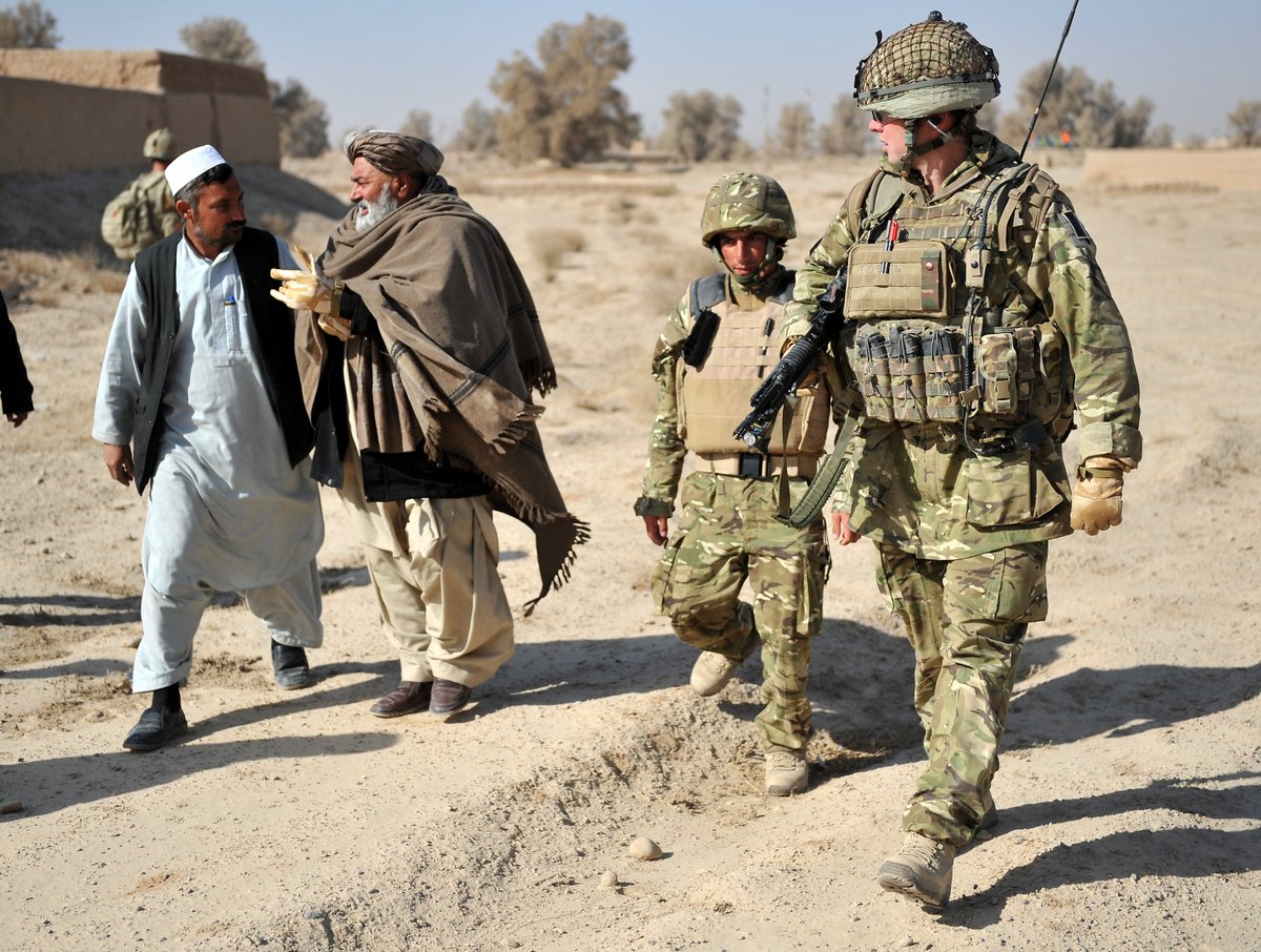 The OC and village elders walk to where the shura is going to be held there is a mixture of Afghan Army, Police, locals and members of 3 Para Battle Group.