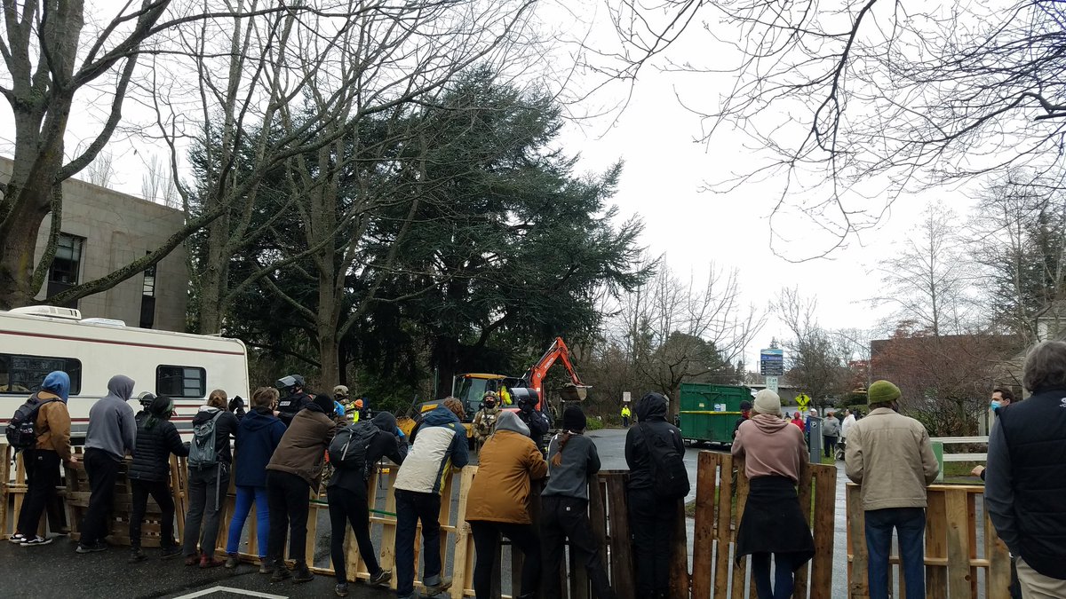 The bulldozers on Commercial have started again. The group who was yelling at the protesters are now laughing at the scene. Here's the scene: