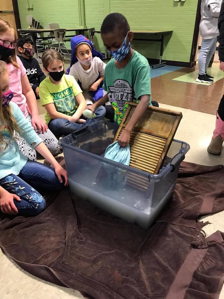 DavidBrewer453's tweet photo. Could you be a pioneer on the frontier? Today students got live like pioneers by hauling water, washing clothes with a washboard, “milking a cow”, make tin art, real candles, butter, and a button whirligig. https://t.co/l19byRyU8M