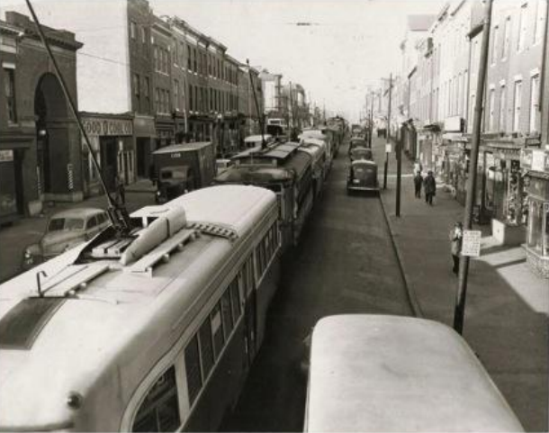 As we continue down Baltimore St, we are in an area that has a strong main street feel but is suffering the effects of redlining, disinvestment, and white flight. Compare it to this picture from 1930 before blockbusting. We also pass Union Square, which is an awesome little park