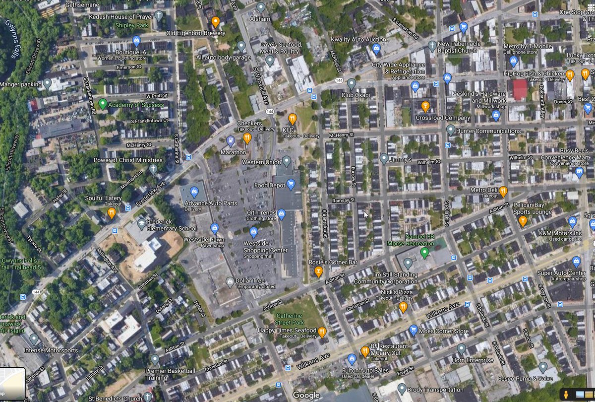 In the middle of dense rowhouses, we have this strip mall, straight out of suburbia. Satellite imagery since 1937 shows that it was used as some kind of nonresidential, then as a strip mall with a massive parking lot, then two strip malls.