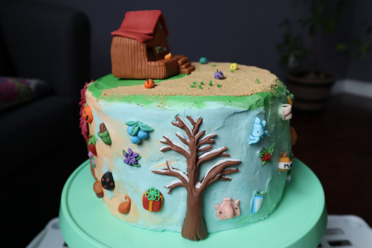 Tall cake decorated with buttercream and various fondant pieces from the game Stardew Valley.