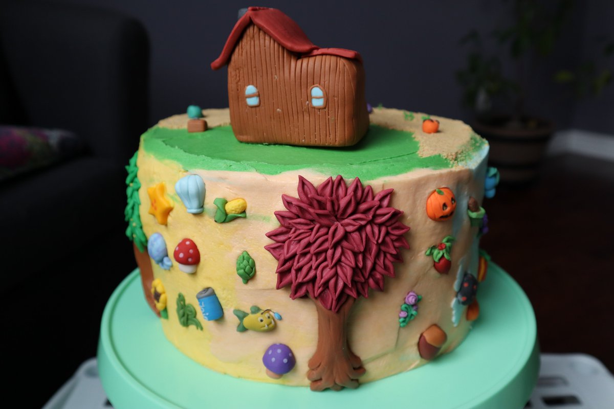 Tall cake decorated with buttercream and various fondant pieces from the game Stardew Valley.