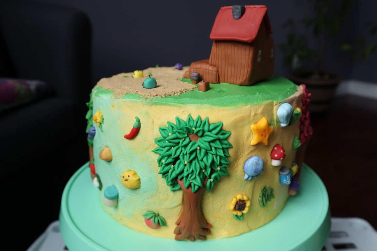 Tall cake decorated with buttercream and various fondant pieces from the game Stardew Valley.