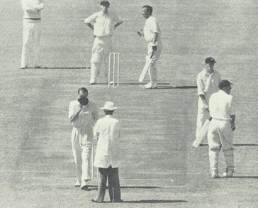 It is tea with England 186 for 6. 46 more required. Cowdrey still at the wicket. Evans joins him. Tayfield is tireless. Before each over he takes off his cap and kisses it before handing it to the umpire.