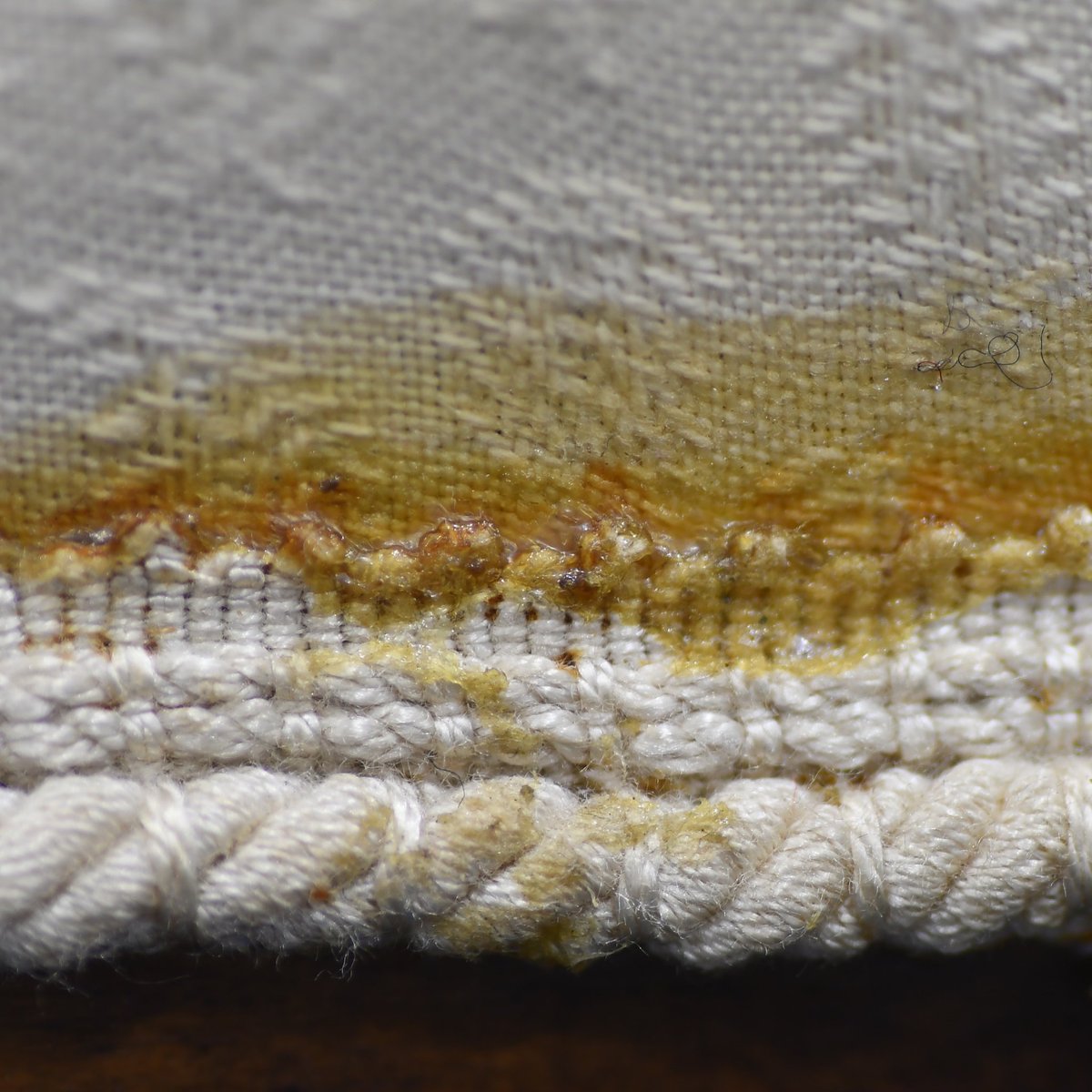 Tex_Con_Ltd's tweet photo. 🕵🏻‍♀️ 🔎 #MacroMonday today is of a previous repair to the gimp (braid) on an upholstered chair. The glue used to reattach the gimp has discoloured over time⏱️ and is now very obvious and disfiguring. https://t.co/NvHcaFqvSv