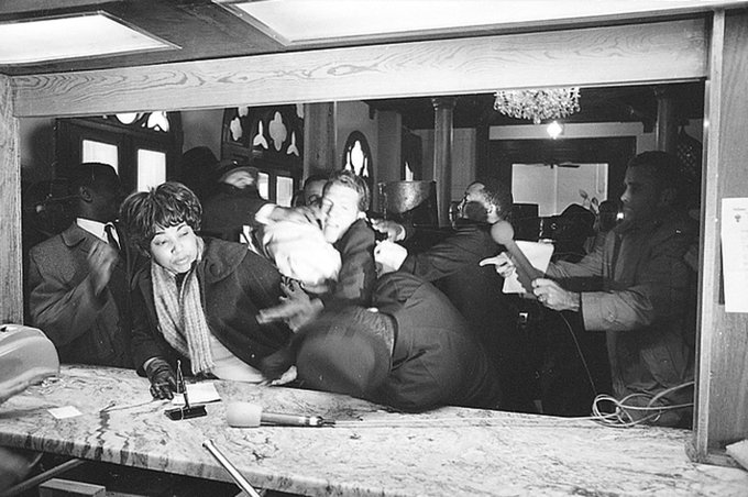 Martin Luther King Jr. is attacked by States Rights Party member Jimmy Robinson as King tries to register at the Hotel Albert in Selma, Alabama, on January 18 in 1965. Photo by Horace Cort.  #OTD  #MLK    #MLKDay    #MLKDay2021  