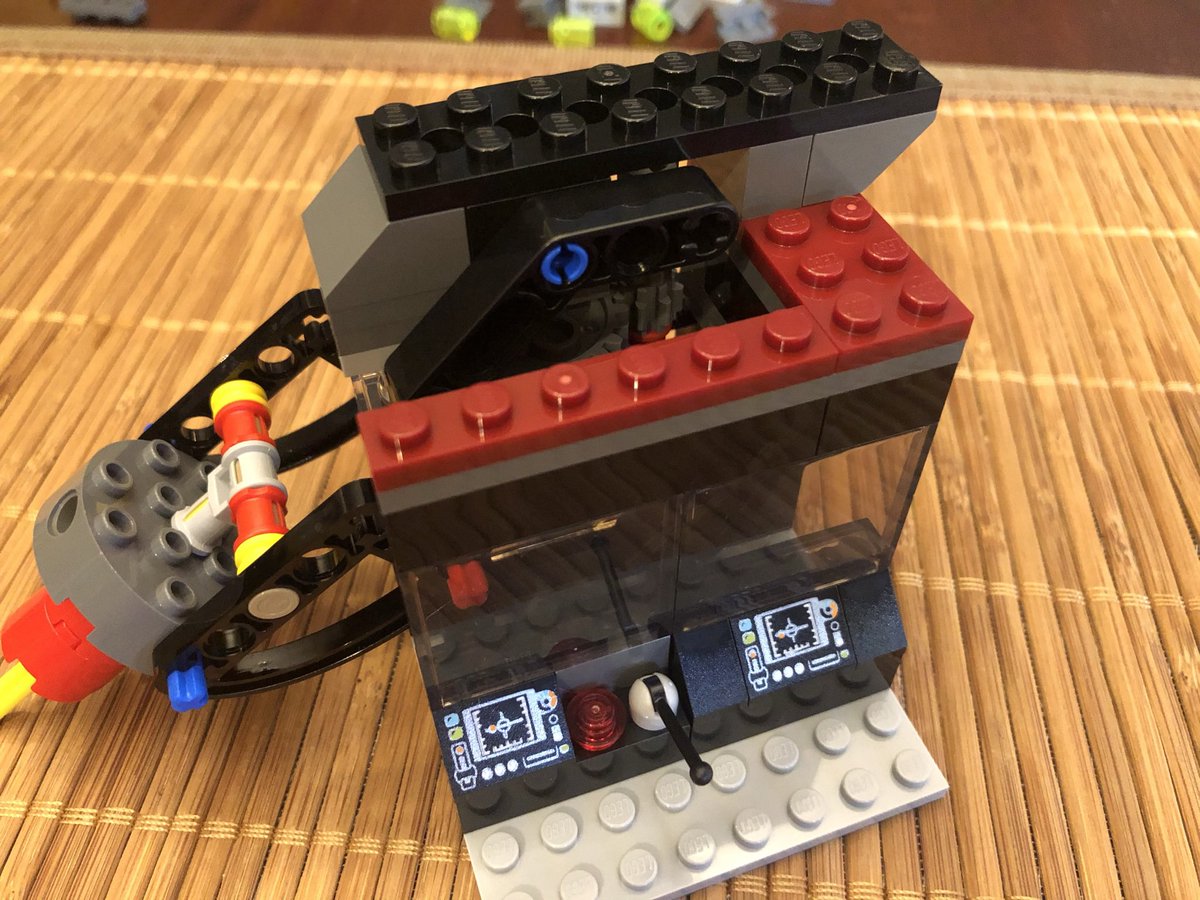 Some glass panels above the consoles and some 1x plates secure the controls and the larger unit, which was rocking a bit before. On the underside we attach a rotating base.  #LEGO  