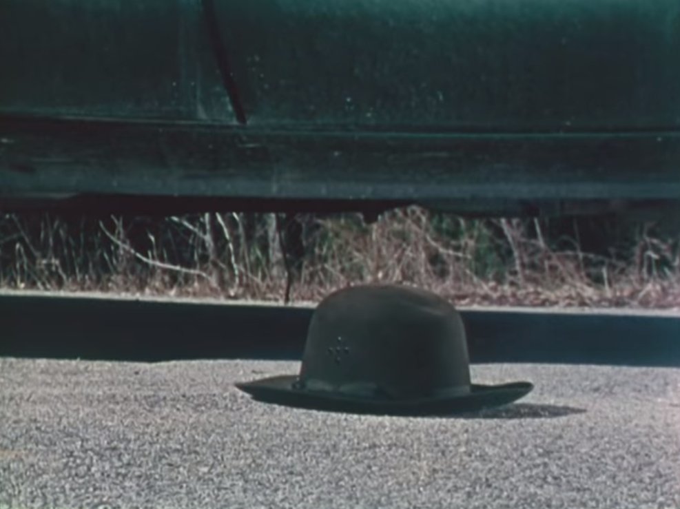 Wise move. Because his rather nice hat takes a ricochet round.