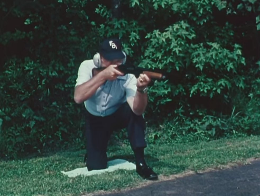 An FBI instructor with a very nice stylised FBI cap on demonstrates how ricochets work with a shotgun. 6/