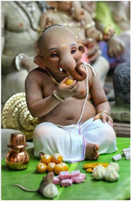 Ganesha was served and he ate on and on. When Anasuya realised that nothing will be left, she served him a single piece of sweet. Ganesh ate it and let out a loud burp indicating that his tummy was now full.This sweet was Modak. Since then devotees serve Modak to appease Ganesh.