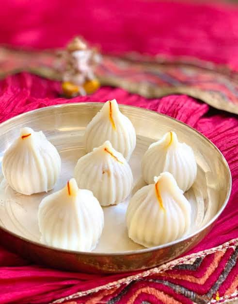 In Maharashtra, Modaks are cooked as both steamed (Ukadiche Modak) or fried dumpling variants. They include grated coconut and jaggery with a hint of nutmeg.Modak is also known as Kozhakattai in Tamil, Modhaka or Kadubu in Kannada, and Kudumu in Telugu.