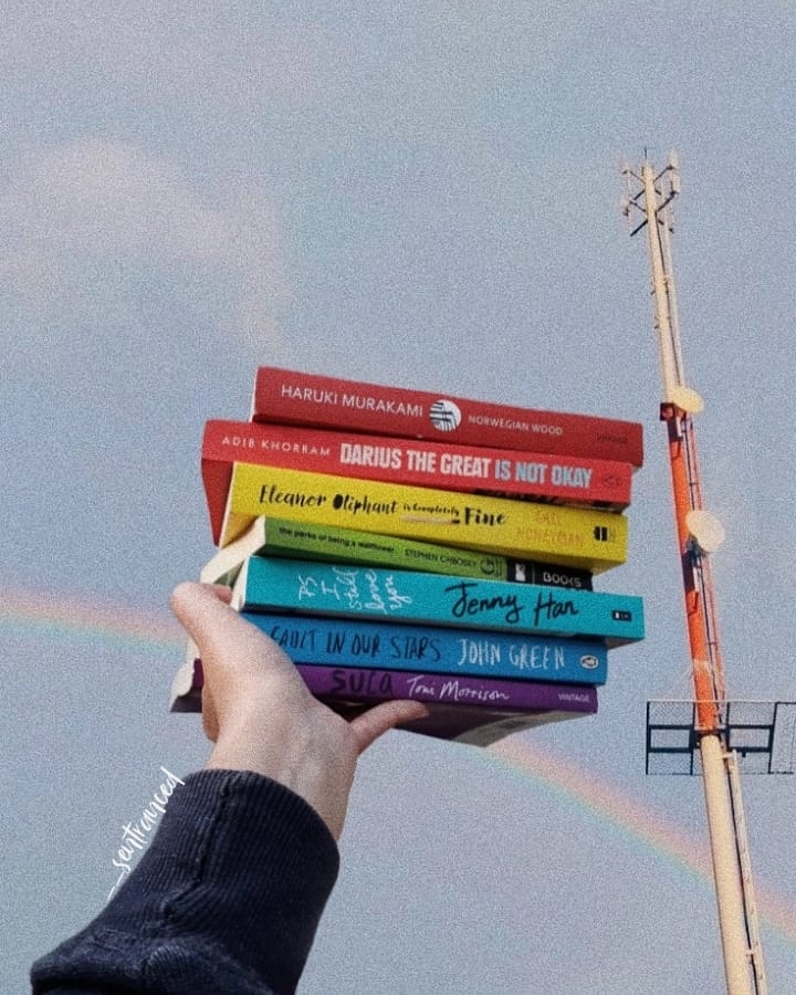 Uh huh, nothing fancy here. Just a beautiful rainbow slowly making its way behind a rainbow book stack! 
#rainbow #rainbowbookstack