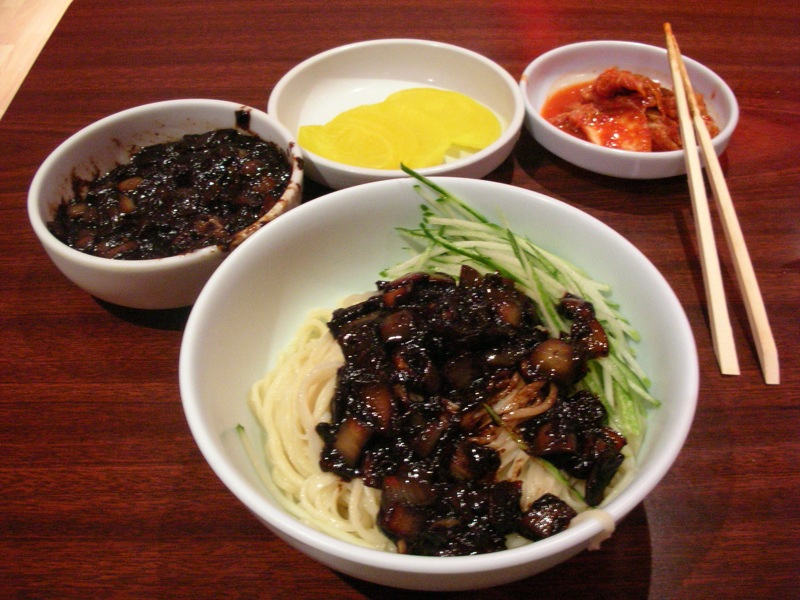 짜장면 (jjajangmyeon) is one of the two ubiquitous Korean Chinese dishes. It's a Korean adaptation of the Chinese dish 炸酱面 (zhajiangmian). But unlike the original dish, which is savory, 짜장면 is sweet.