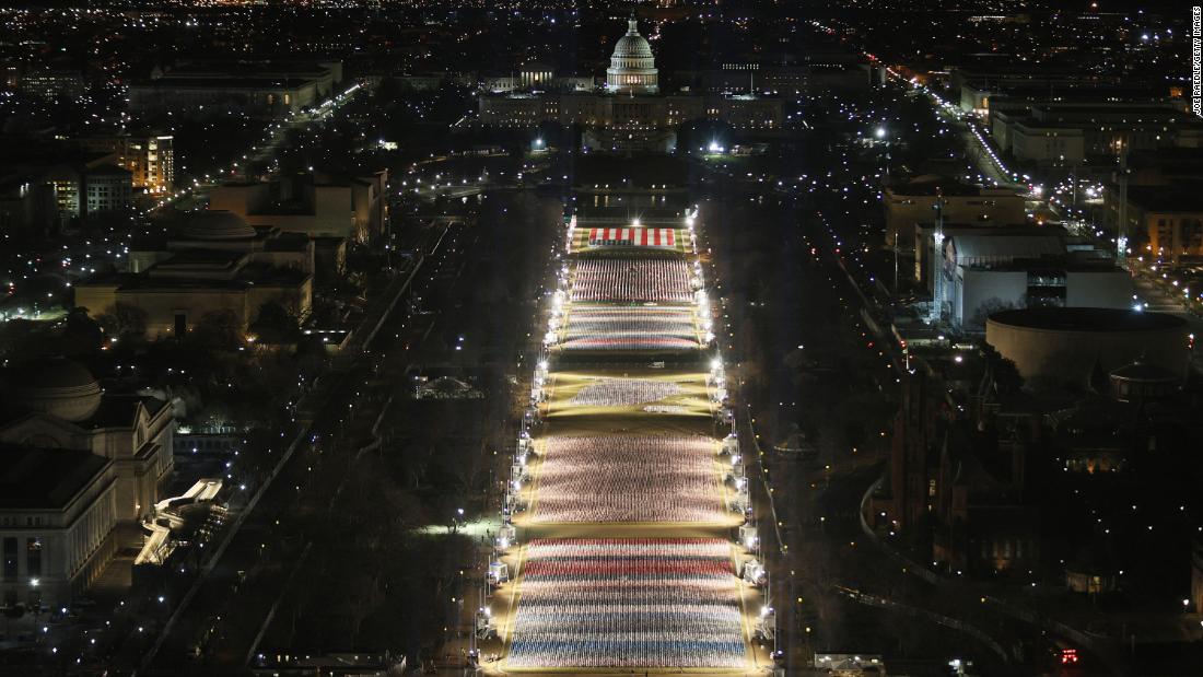 CNN's tweet photo. More than 191,500 American flags have been planted on the National Mall. They represent the Americans who can't attend Joe Biden's inauguration due to the pandemic as well as heightened security concerns after this month's insurrection at the US Capitol. https://t.co/YSqnE2GbMV https://t.co/kYpNE1pdIS