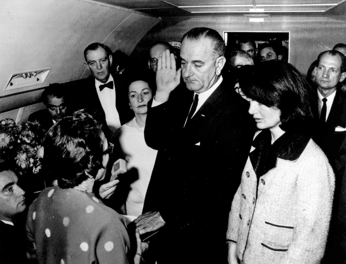 The second was more somber.“Jackie O” stands beside Lyndon B. Johnson as he’s sworn in inside the presidential plane — just hours after JFK was shot and killed. (AP/Cecil Stoughton)