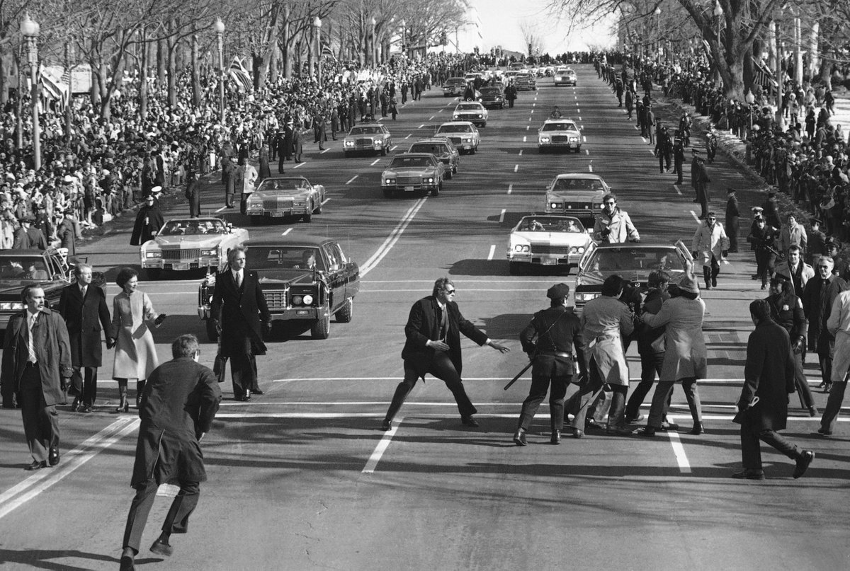 At Jimmy Carter’s inauguration in 1977, he became the first president to walk down Pennsylvania Avenue — now a tradition.A spectator burst into the Inaugural Parade, only to be quickly detained by police and Secret Service. (AP Photo)