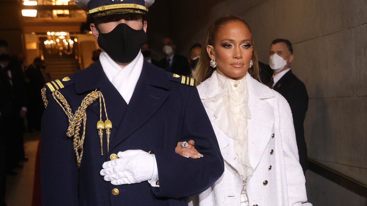 VogueRunway's tweet photo. .@JLo chose suffragette white for her #InaugurationDay performance https://t.co/rux3KGAH0Q https://t.co/OobLAsNX42
