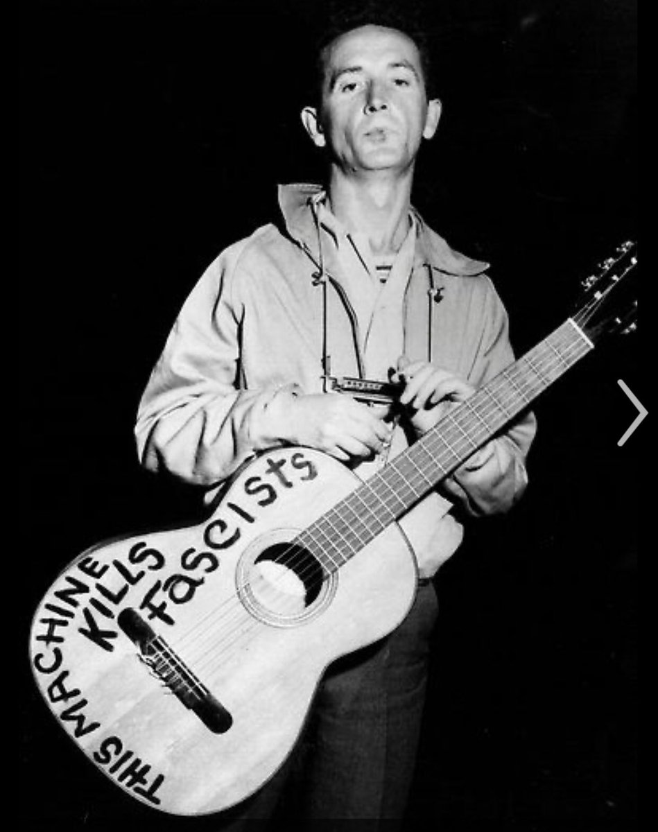 In this modern context, it's a very interesting and importance choice. Guthrie is notable in the context of this transition for two reasons: 1. he was adamantly anti-Fascist to the point that he wrote "This Machine Kills Fascists" on his guitars.