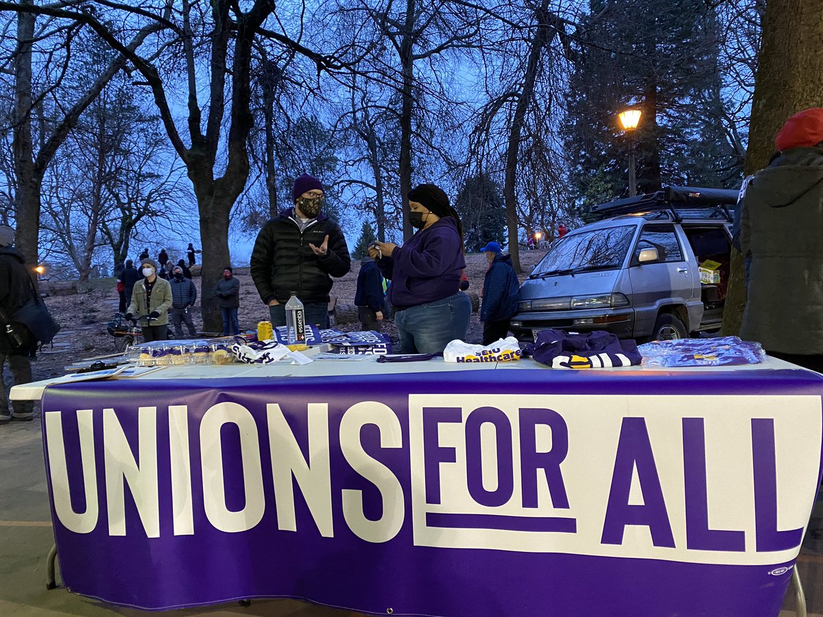 A number of organizations have tables set up for people, so that they can spread their message and increase support. One of these groups is a local labor union of hospital and sanitation workers.