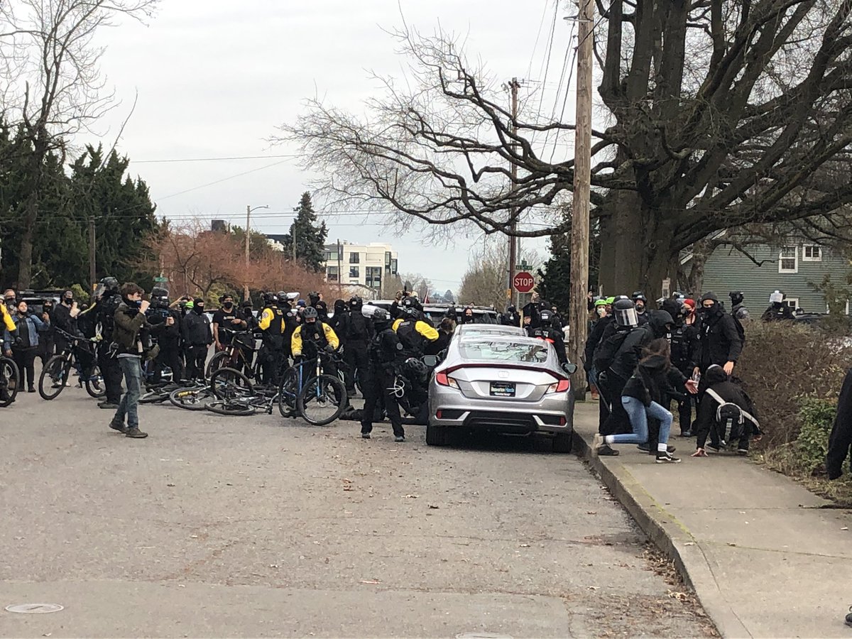 A scuffle just broke out. Bike cops jump on a person, seem to be arresting them on the ground.