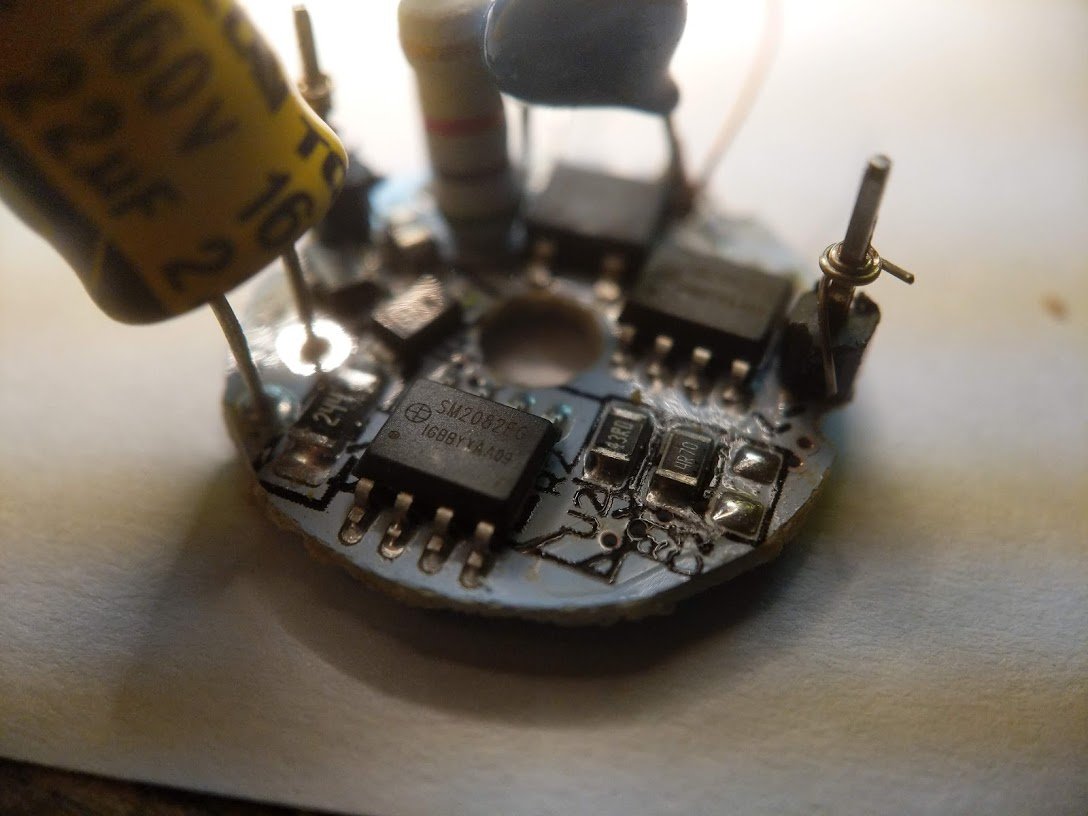 now let's look at the circuit board. it's got a bridge rectifier, some off-brand capacitors, a fusible resistor, and two chips. SM2082. hmm.