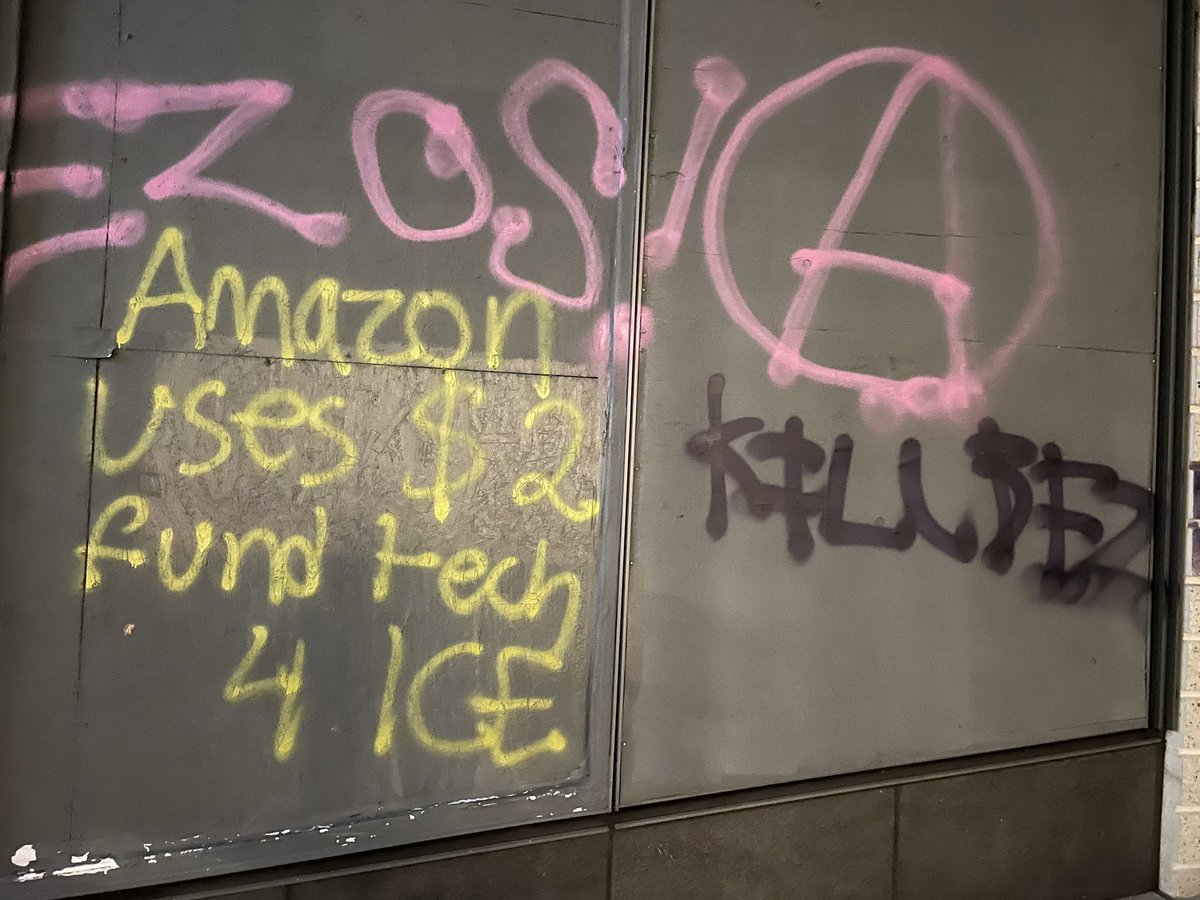 In Seattle, a group of about 150 protesters in black bloc burned an American flag outside the immigration court on 2nd Ave, smashed a window at the Amazon Go. Police are now trailing.
