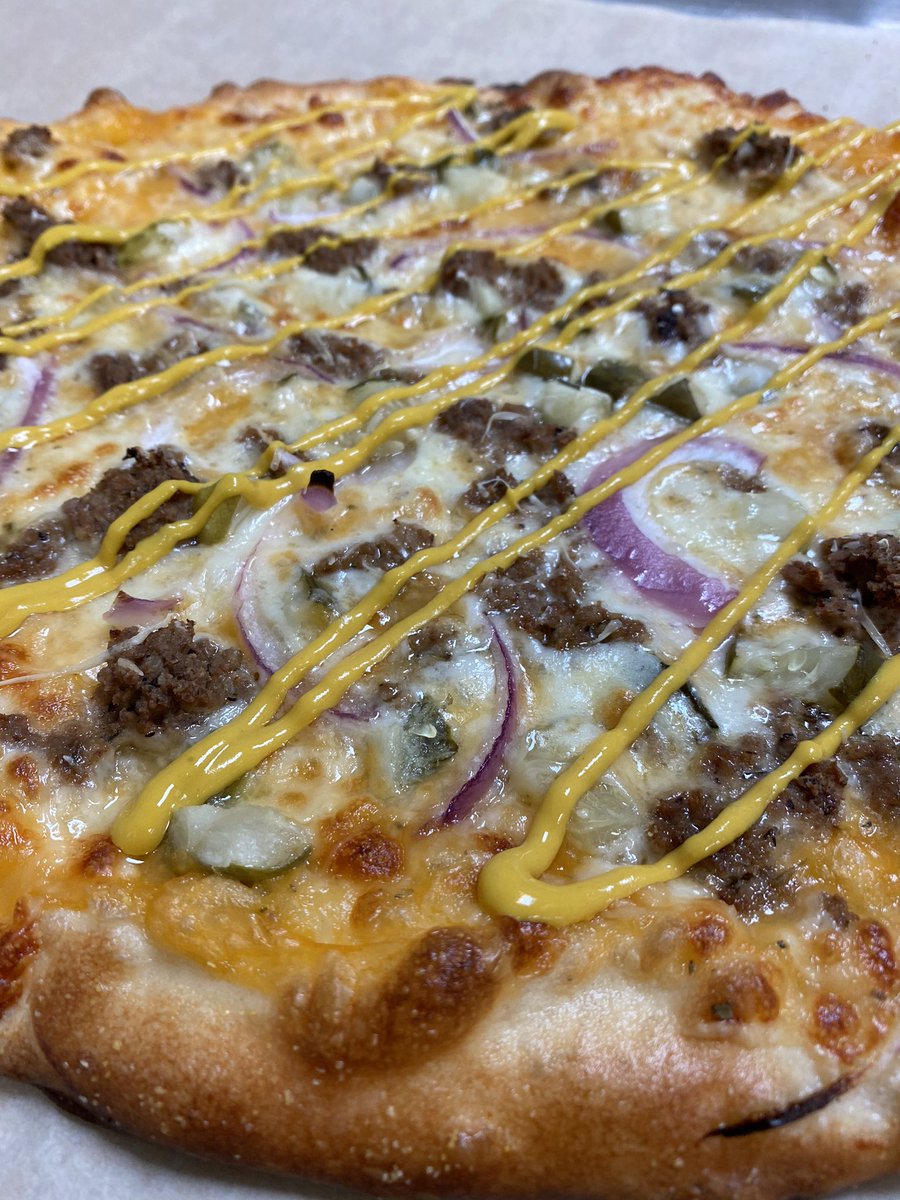 Specialty Pizza Alert!  The Need•Rite-nachos cheese based pizza with loose meat, red onions, pickles, mozzarella and finished with mustard!