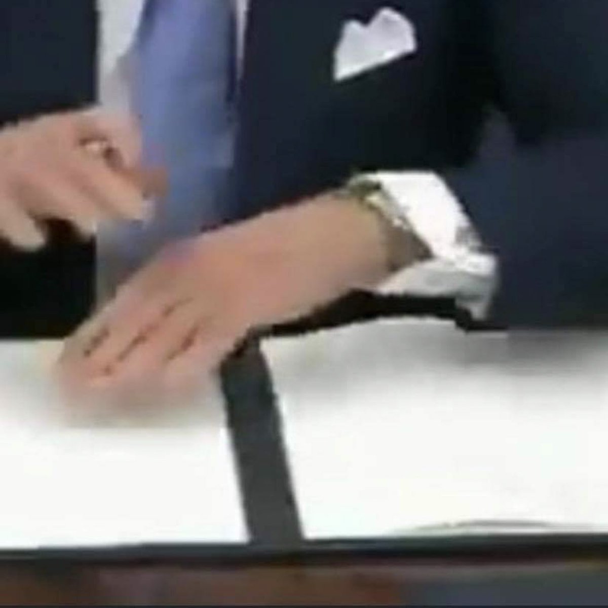 In the next photo (taken from the original video of him signing EO’s) you can see from every angle of the video that these pages are blank, and to debunk the whole camera overexposure hypothesis which I originally thought, where is the seal that is supposed to be on the page?...
