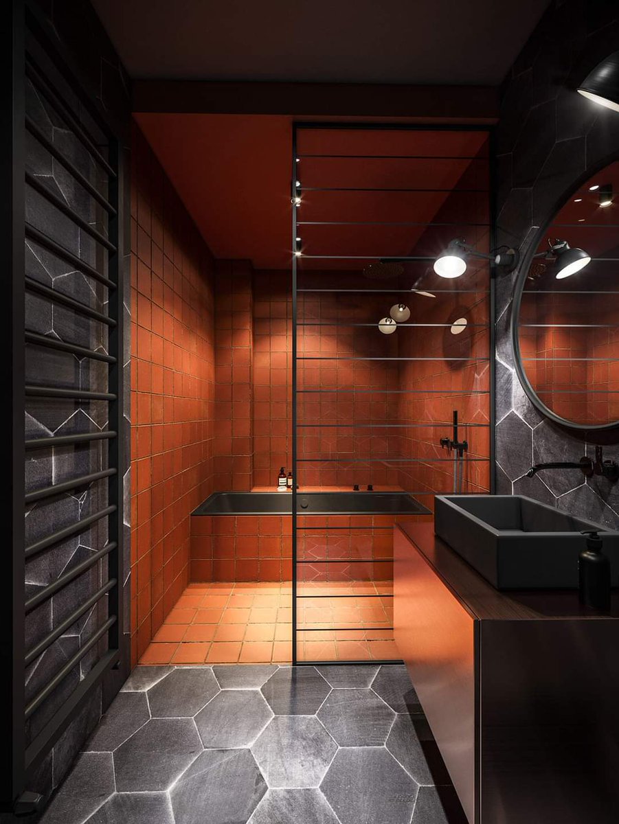 Burnt orange tiles rage inside the wet room..................Contrasting  cold grey hexagonal tiles only make the orange tiles burn  brighter.......Making lite bathrooms 🔥🔥🔥🔥 #interiordesign #IkoKaziKE, image size:901x1200