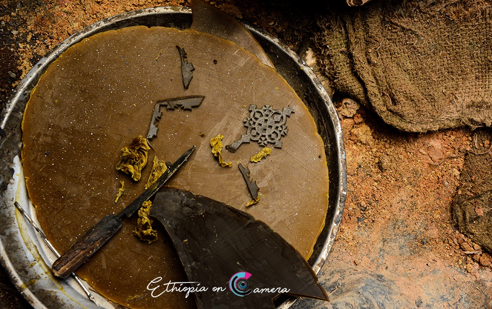 3/5 The process begins with beeswax. Heated over charcoal, it’s softened to the right point for carving fine details, but hard enough to retain its shape.