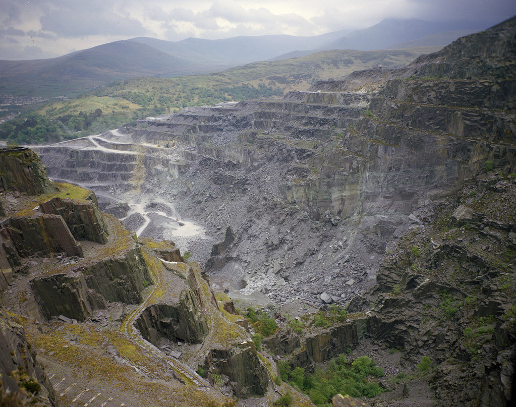 Slate in North Wales occurs in a range of colours but the quarry at Penrhyn is famed for the production of purple-red slates.

The 📸 is of the east face of the quarry (1974) which, along with the purple, shows the 'grey slates' and green sandstone.
