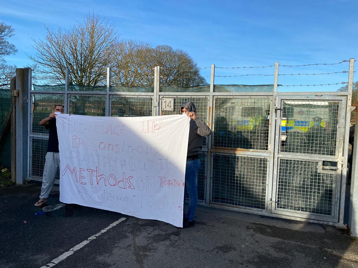 More images sent to me from inside Napier Barracks today, showing police surrounding the camp & filming asylum-seekers insideThe protest banner held by residents reads: "This place is like prisons in our country, but the methods of torture are different"