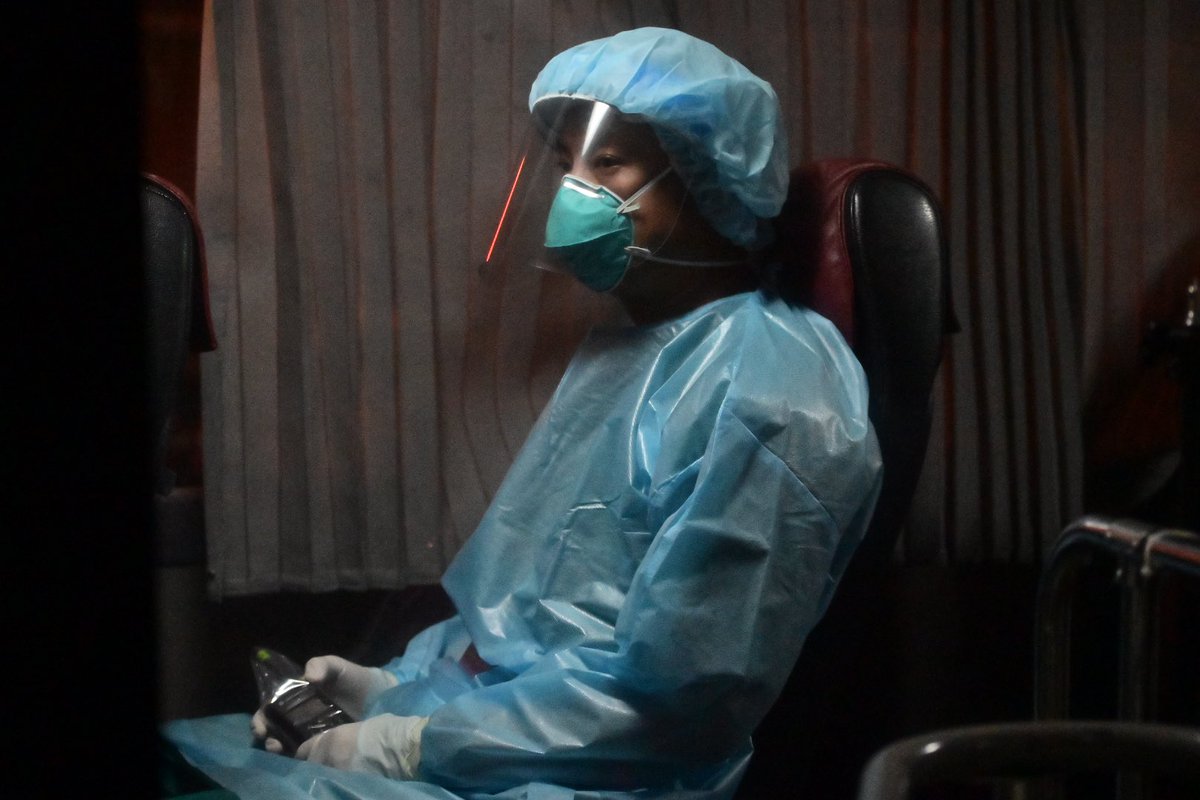 Medical staffers waiting in van with PPE and N95 mask