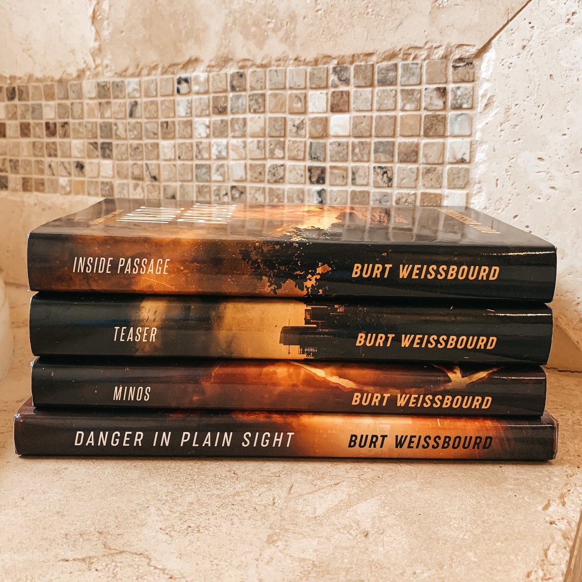 Four books stacked on counter