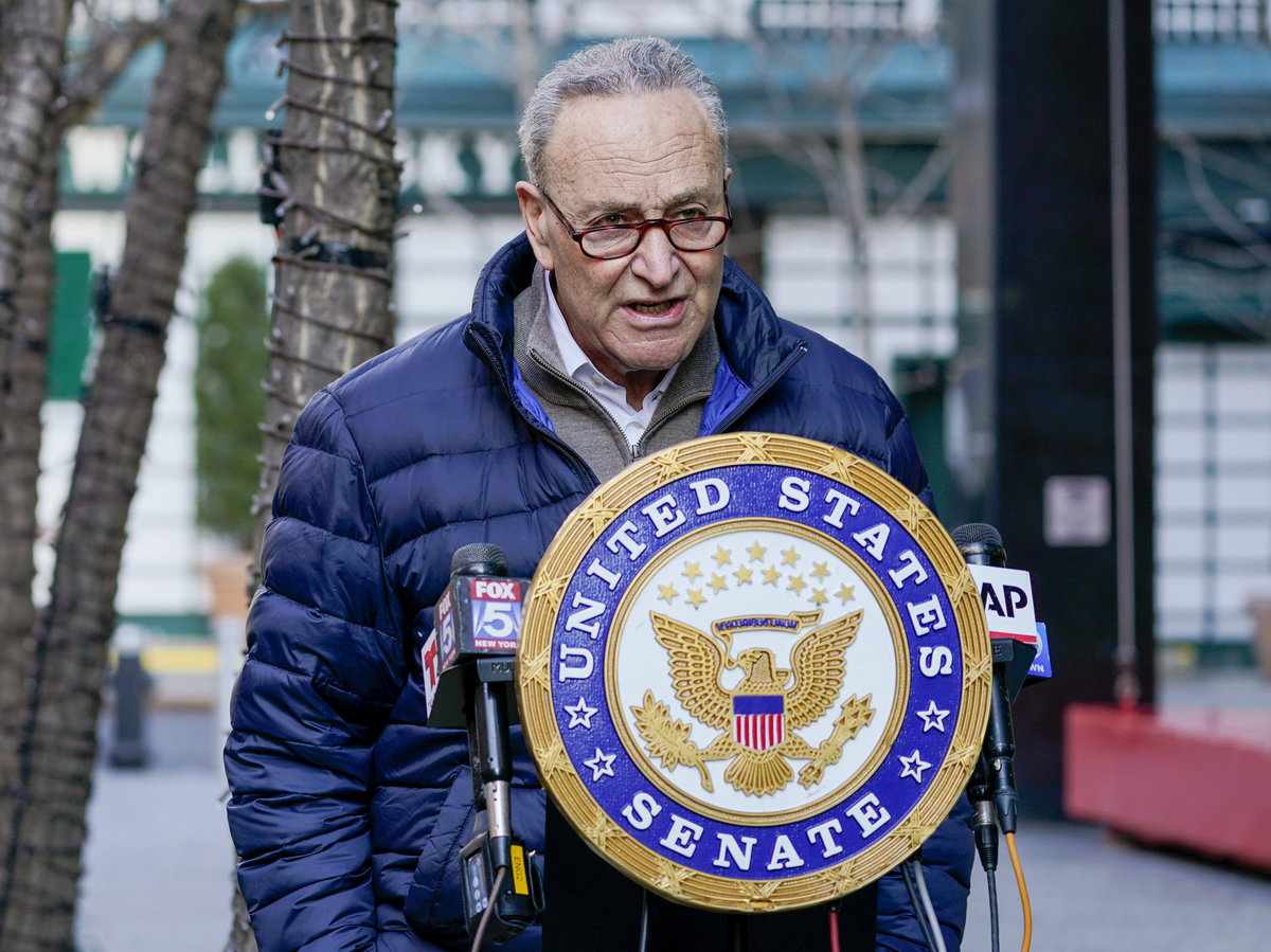 Chuck Schumer in a reasonable puffer coat outside