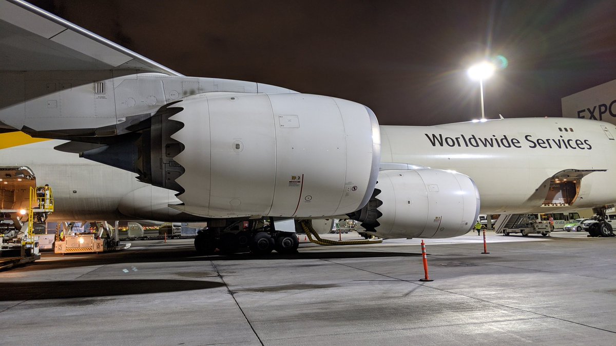 Hot air from the engine core mixes with the cooler air blowing through the fan. The shaped edges serve to smooth the mixing which reduces turbulence that creates noise.  @GEAviation care to add anything.