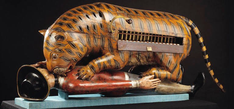 Tipu's Tiger, an 18th-century mechanical toy, now exhibited at a museum in LondonIt depicts a tiger overpowering a British soldier. Keys make the tiger 'grunt' & the victim 'wail and move his hand helplessly'.The tiger expresses his hatred of his enemy, the British. 5/8