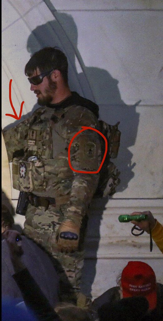 Magnolia has slick military kit. He appears to be wearing a black hoodie under camo & has a magnolia patch and two Punisher patches. One is where his rank would be, so it’s likely he is not current or former military. A soldier is not likely to do that.