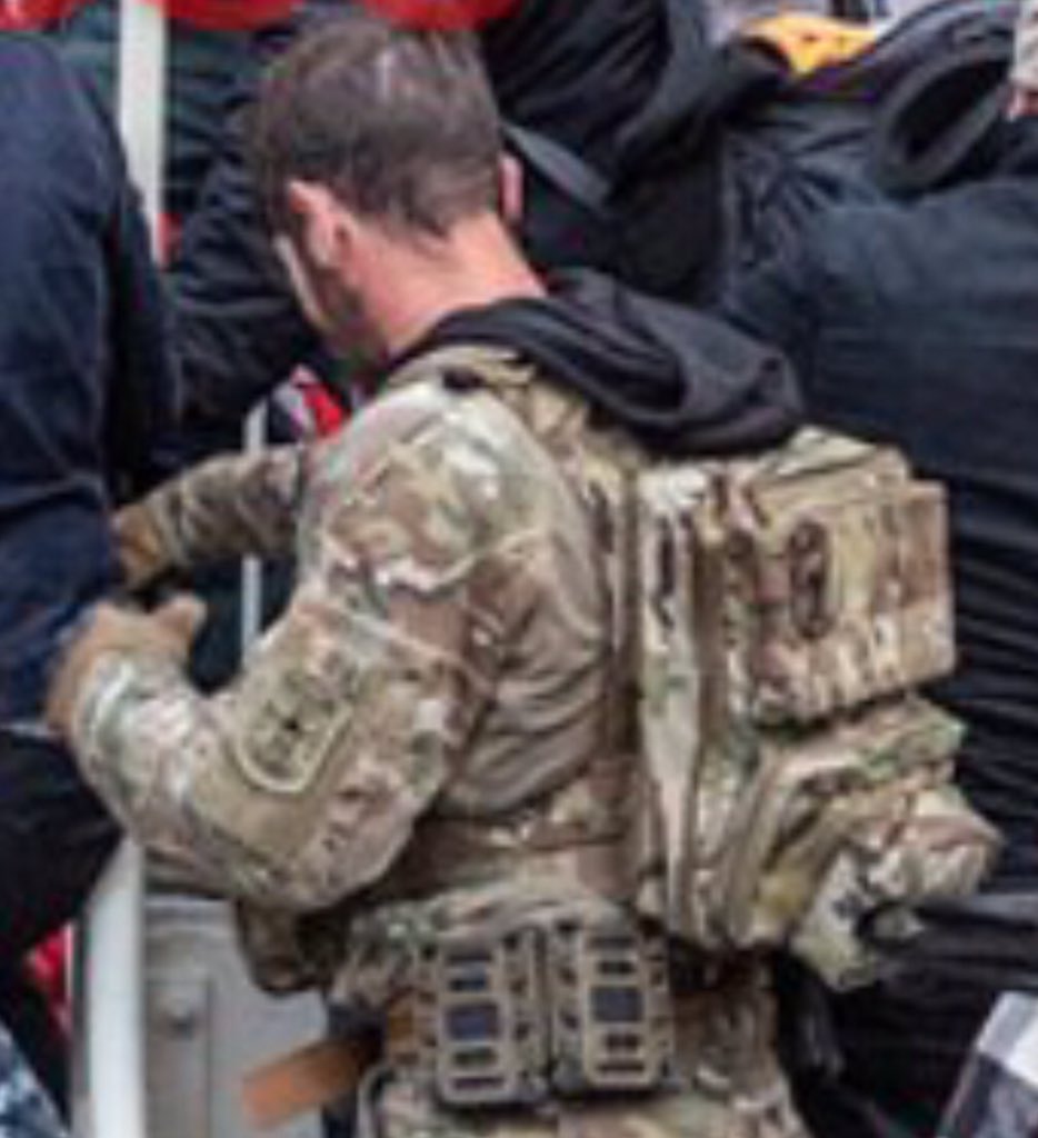 Here’s an up close of Magnolia’s kit. I have been told his “uniform” & set up are not cheap & perhaps a knock off SOF. Can we ID it?Can anyone make out the backpack manufacturer or symbols on there?