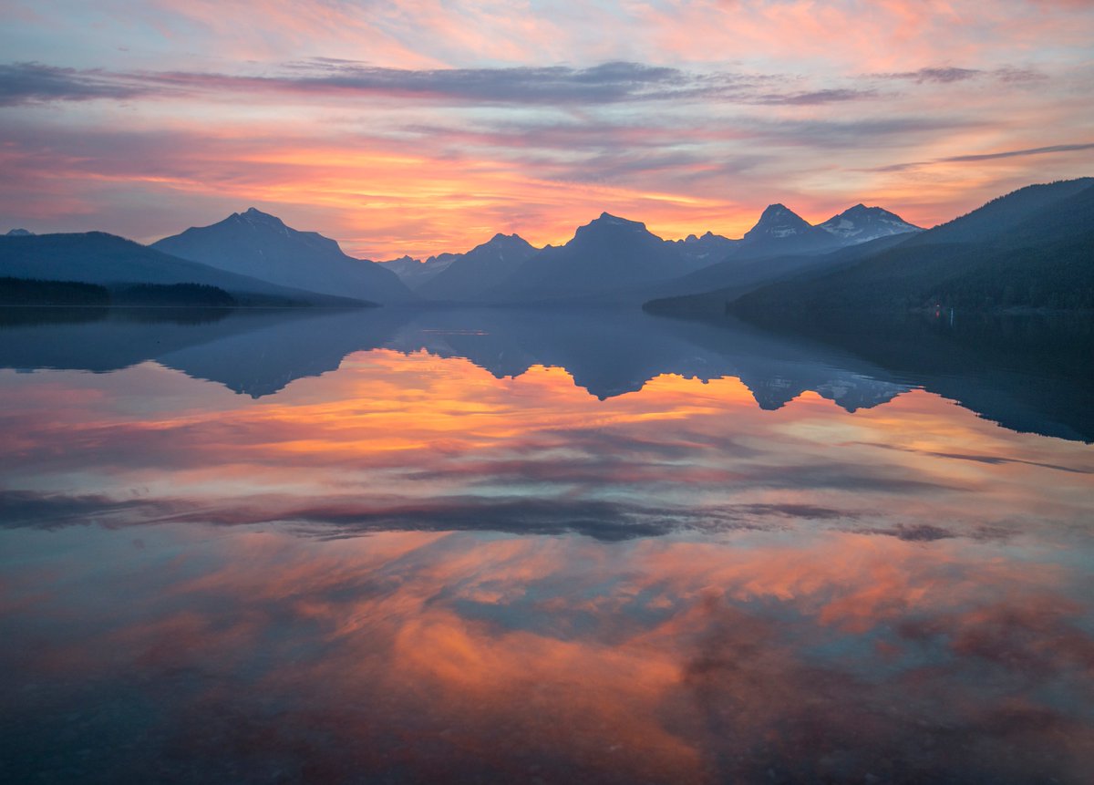 Interior's tweet photo. Even the rangers who see this every day will tell you, this view never gets old. Lake McDonald in @GlacierNPS #Montana certainly makes our list for “spectacular places to enjoy a cup of coffee and watch the #sunrise.” What’s a favorite spot of yours? https://t.co/wiVgCrRrkB