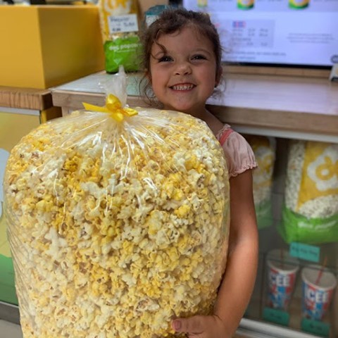 DocPopcornWI's tweet photo. Allie is all set for her family movie night! Stop by the kiosk today and pick up a party bag for yourself! https://t.co/yGBhhYz7w1