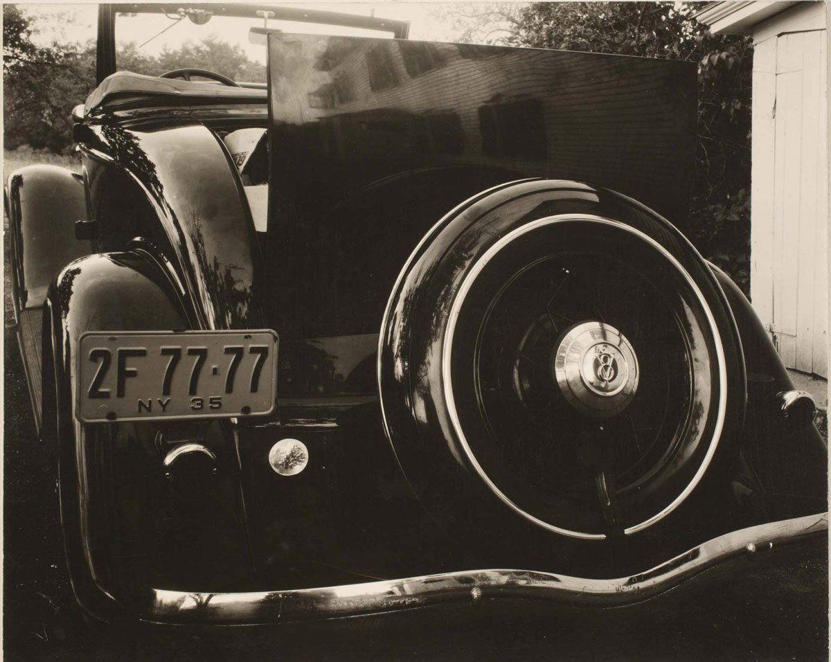 Was compelled to research a bit more, and this 1935 Stieglitz photo confirms a 1933 Ford Deluxe Cabriolet, one of the bitchin-est cars ever in my book.