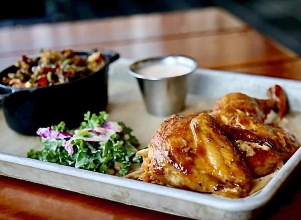 Savor the flavor of our Brick Oven Smoked Chicken with Alabama white sauce, crispy brussels and kale slaw. It is available for both dine-in and carry out!