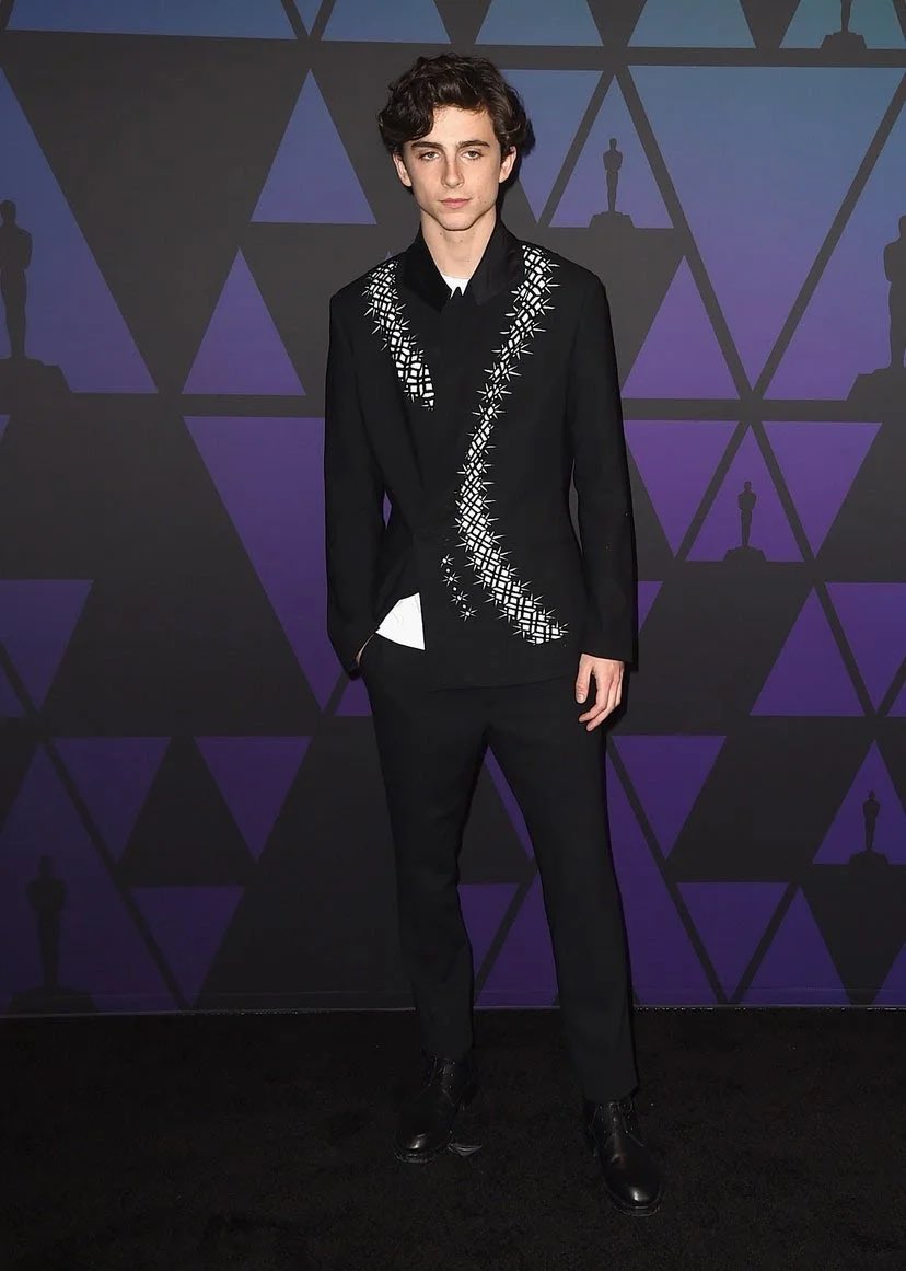 18 November 2018He wore Haider Ackermann for the 2018 Governors Awards in Hollywood.3 January 2019Timothée arrived for the 30th Annual Palm Springs International Film Festival Awards wearing a grey double-breasted suit with brown boots.