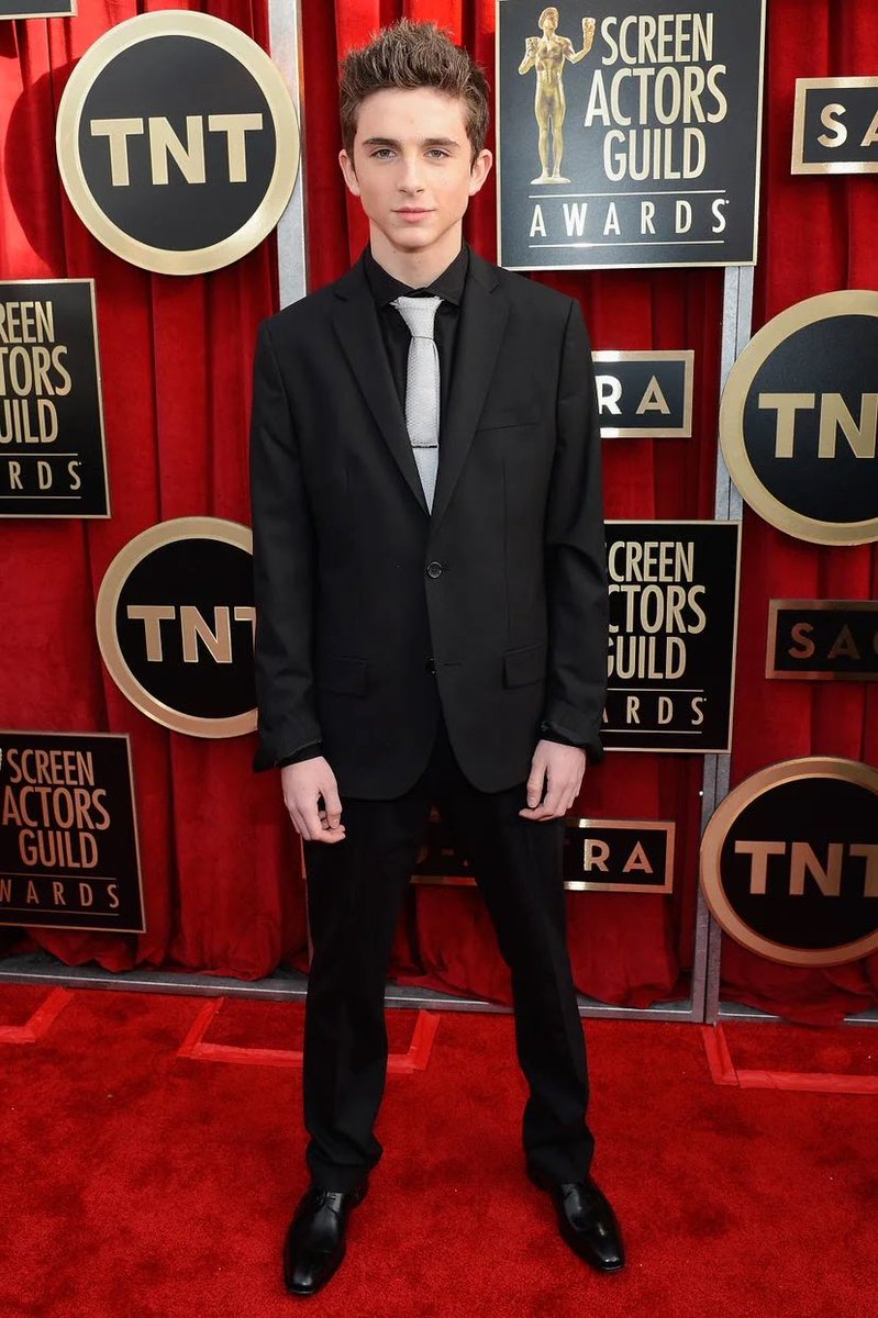 26 January 2013Timothée Chalamet attended a pre-SAG party in Los Angeles wearing a black shirt with a patterned tie and skinny jeans.27 January 2013A 17-year-old Timothée wore a black suit with a silver tie to the 2013 SAG Awards.