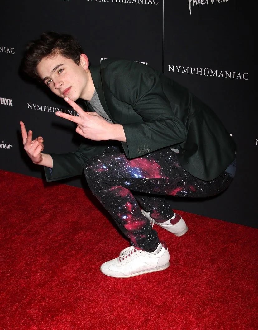 13 March 2013Nymphomaniac: Volume I premiere at the New York Museum of Modern Art wearing an intergalactic-print pair of trousers.24 June 2014Back at the MOMA, Timothée wore cut-off shorts with beat-up Vans and a green blazer for the Snowpiercer premiere.