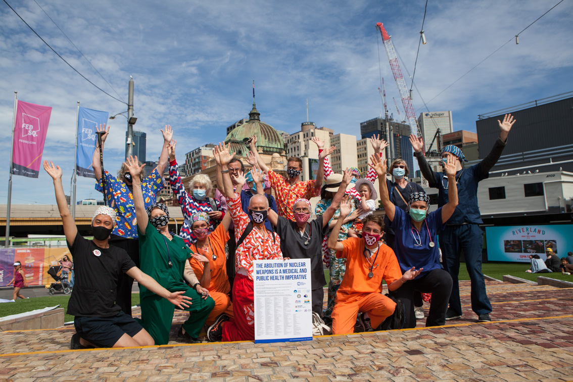 Melbourne doctors - in scrubs - welcome the TPNW's entry into force on Federation square with a sign saying "The abolition of nuclear Weapons is a medical and public health imperative." Melbourne isthe city where ICAN was born. Photo:  MAPW AU