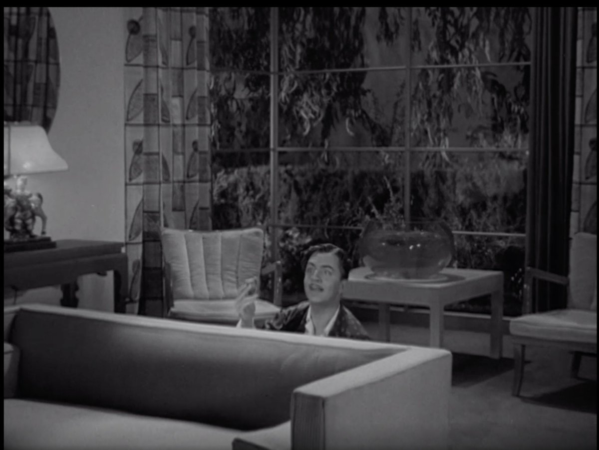 The reverse of the same room. Obviously, this was built on a stage but DEAR LORD the scale! The high ceilings! Those windows! Even the fish bowl is gigantic.